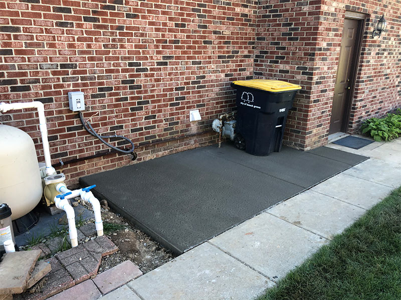 simple concrete pad for trash cans